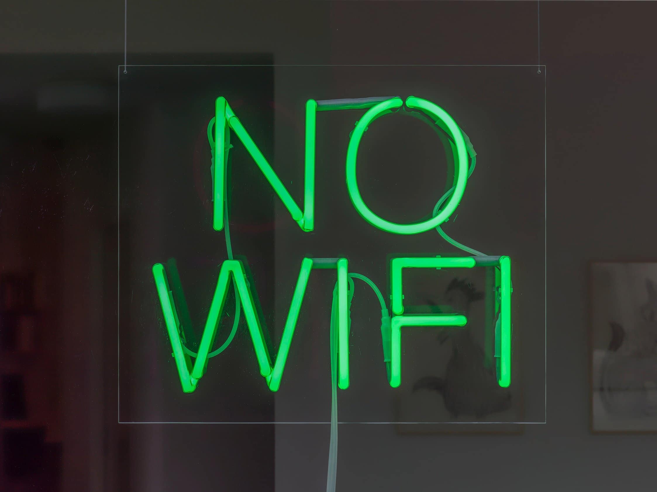 Green neon letters in all caps saying NO WIFI