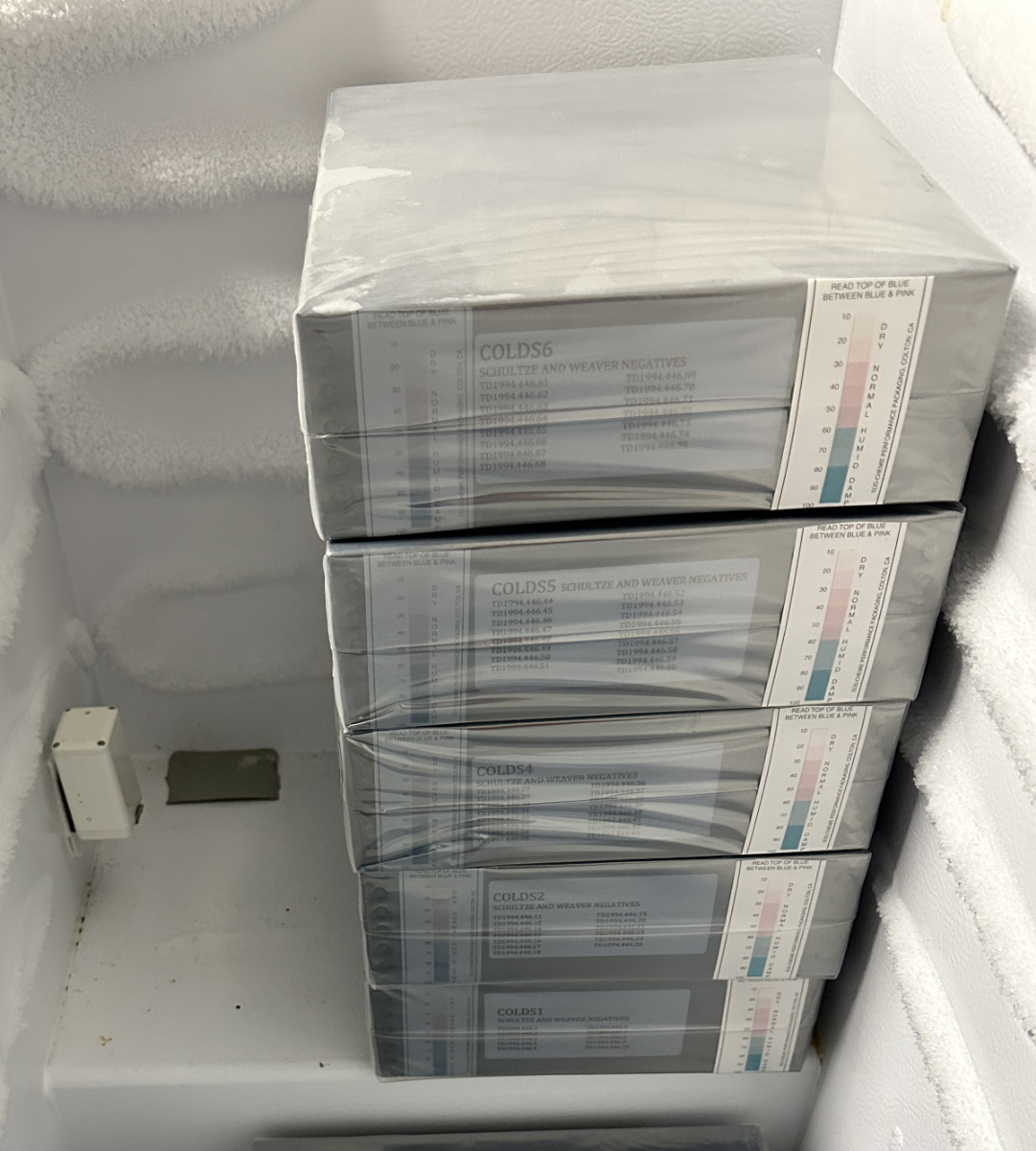 Stack of wrapped boxes containing the Shultze & Weaver negatives placed in a freezer unit with a Conserv Cold Storage Sensor for monitoring. Image courtesy of The Wolfsonian–FIU, Miami Beach, Florida.
