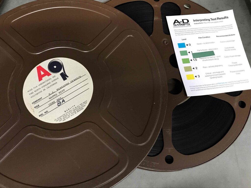 Collections Assessment for Preservation at the Disaster Research Center Watts Riot film reel with A-D strips to check for degradation showing a dark green 1 out of 3 rating for "Fair to Good - deterioration. Recommended action Cold storage, monitor closely."