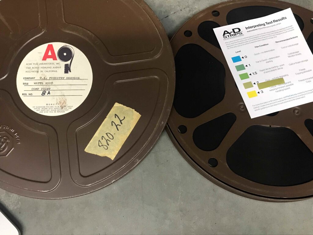 Collections Assessment for Preservation at the Disaster Research Center Watts Riot film reel with A-D strips to check for degradation showing a light green 2 out of 3 rating for "Poor - actively degrading. Recommended action Freeze, copying advisable"
