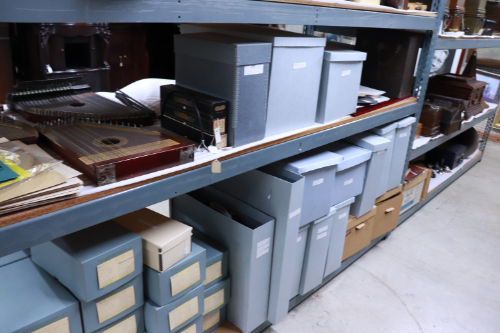 Image of orderly light blue boxes with lids on museum storage shelves at the Arizona History Museum in Tucson.