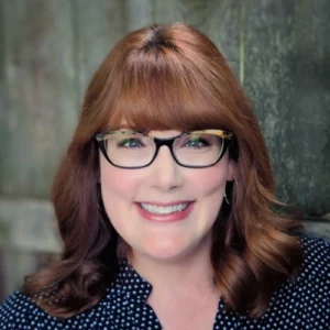 Headshot of smiling woman with glasses. Historic building preservation monitoring at Walsh University.