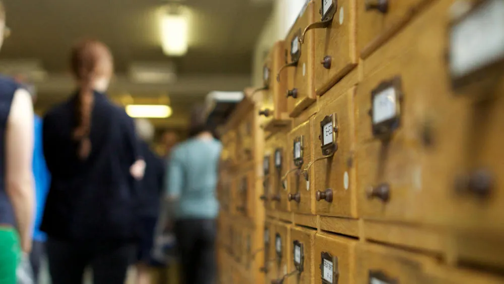 People walking through hallway at The London Archives